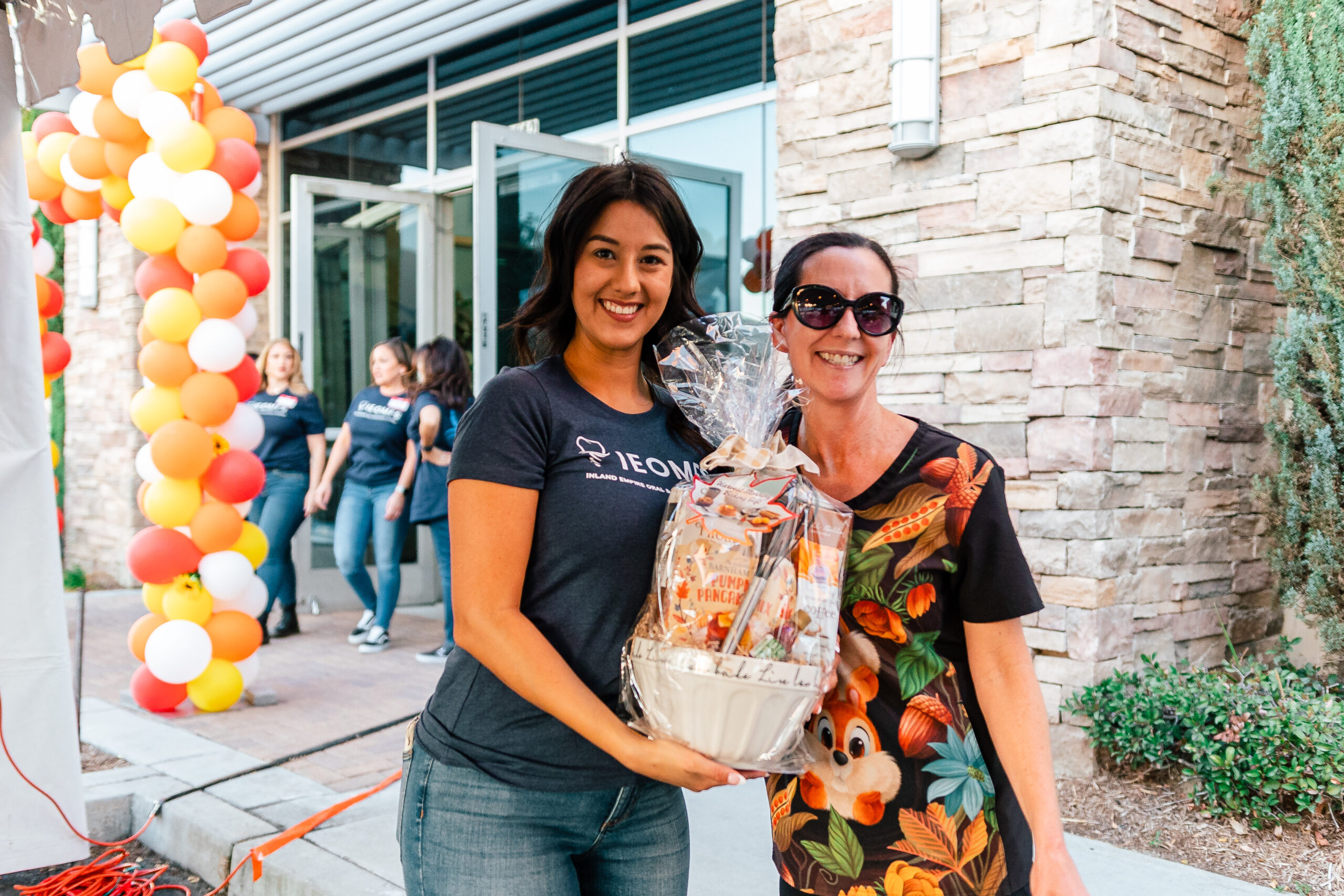 Staff engaging attendees at IEOMFS anesthesia services information session.