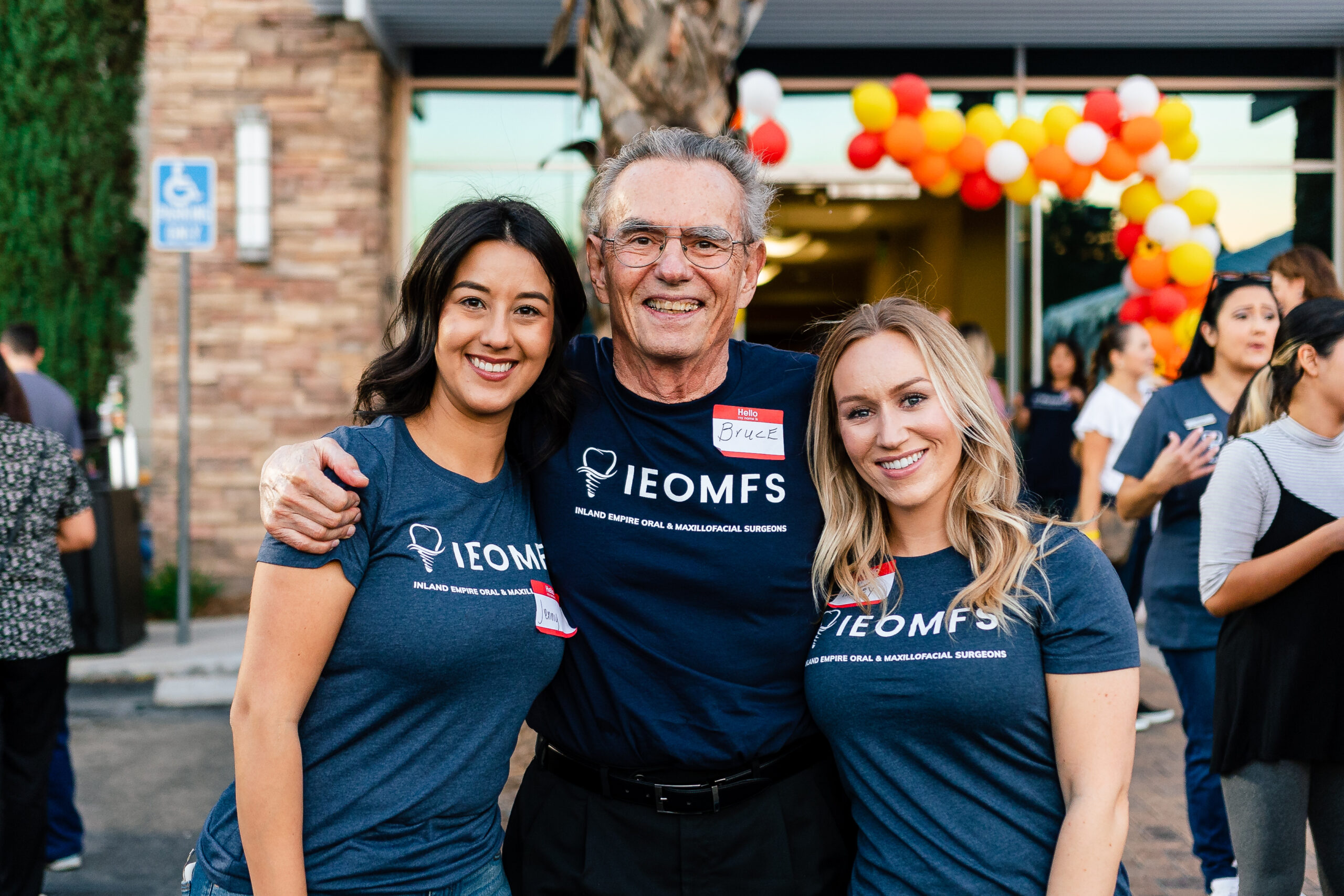 IEOMFS surgeon explaining sedation options to patients at community event.